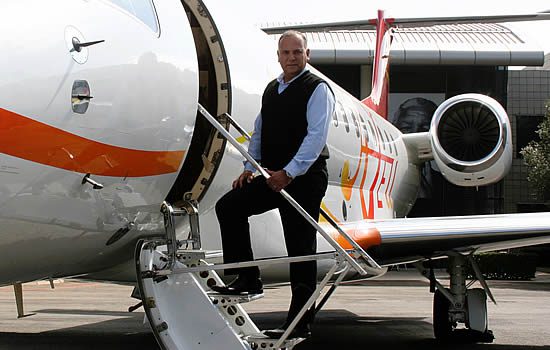 Vince Goncalves next to an Embraer Legacy at their South Africa facility.