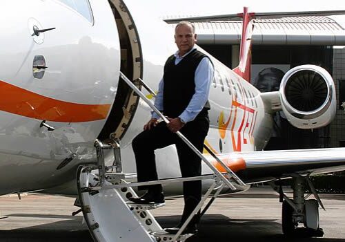 Vince Goncalves next to an Embraer Legacy at their South Africa facility.